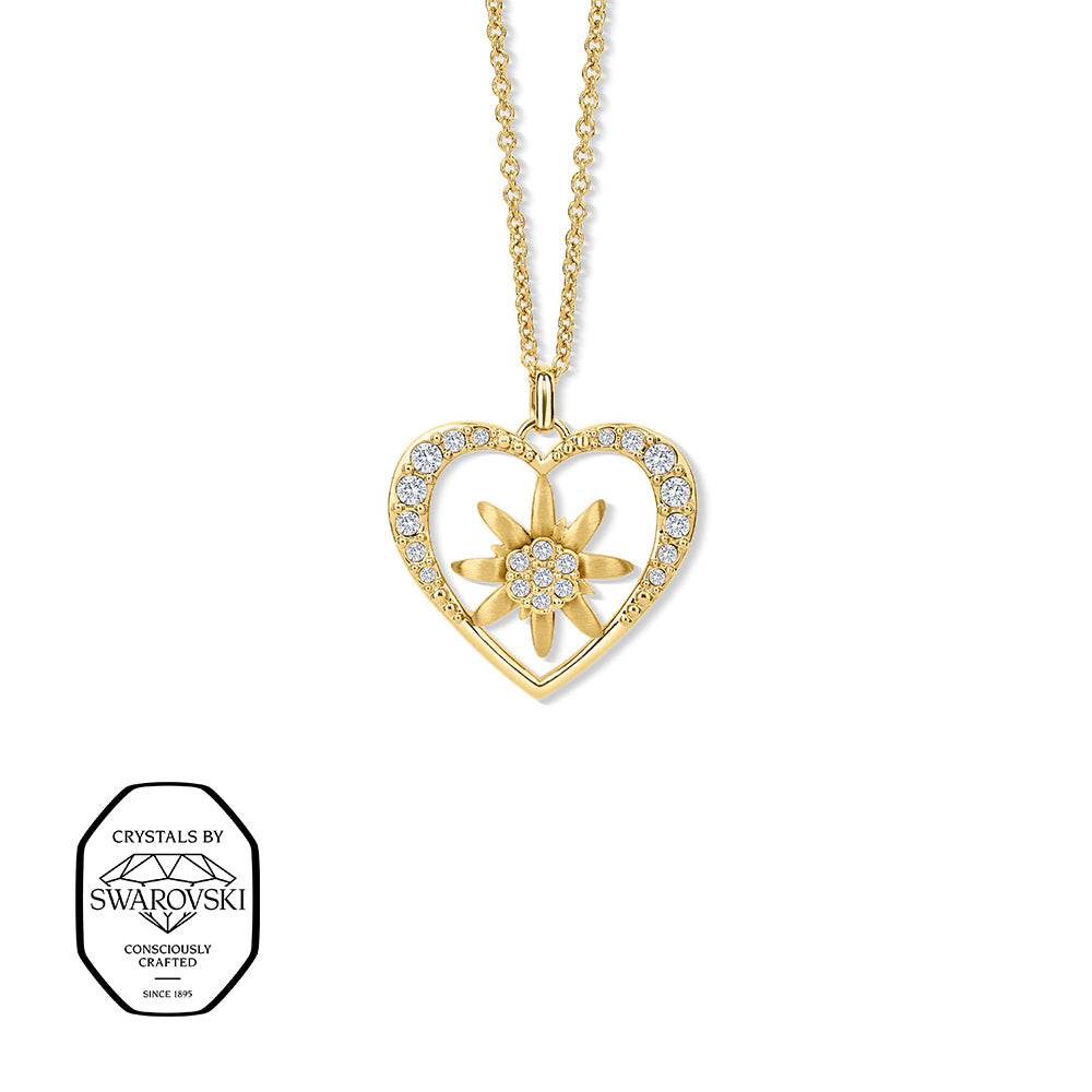 Vergoldete Halskette mit herzförmigem Anhänger, besetzt mit Swarovski® Kristallen. In der Mitte ein Edelweiß mit funkelnden weißen Swarovski® Kristallen.