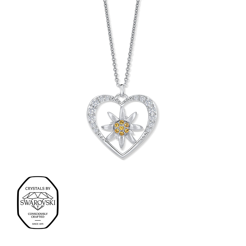 Silberne Halskette mit herzförmigem Anhänger, besetzt mit Swarovski® Kristallen. Im Inneren ein Edelweiß mit gelben Swarovski® Kristallen.